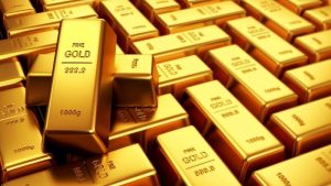 Gold edges lower on higher US yields, firm dollar